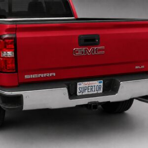 Black vinyl rear sill plate installed on the rear bumper loading edge of a GMC Sierra or Chevrolet Silverado.