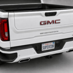 Black vinyl rear sill plate installed on the rear bumper loading edge of a GMC Sierra or Chevrolet Silverado.
