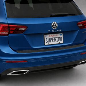 Black vinyl rear sill plate installed on the rear bumper loading edge of a 2023 Volkswagen Tiguan.